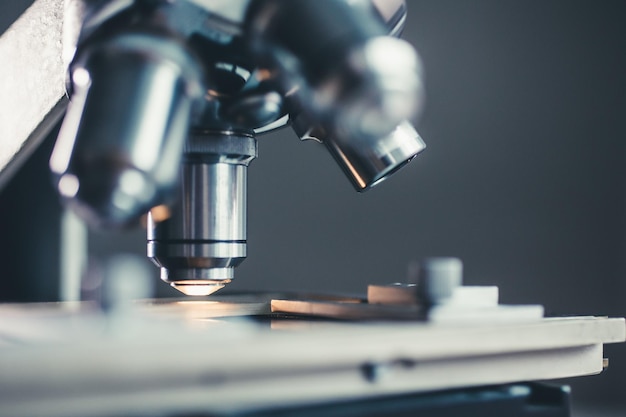 Closeup shot of microscope with metal lens at laboratory