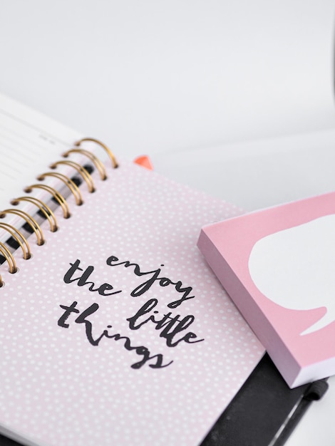 Closeup shot of a notebook with a writing "enjoy the little things"