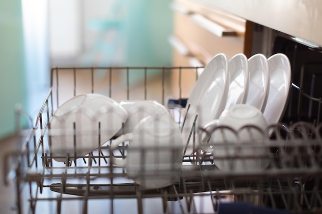 Closeup Shot Of Open Builtin Dishwasher Machine With Clean Dishes