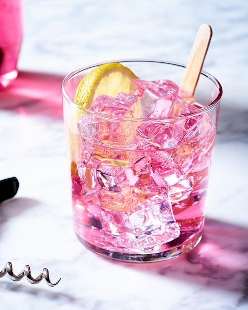 Closeup shot of a pink cocktail drink on a marble table