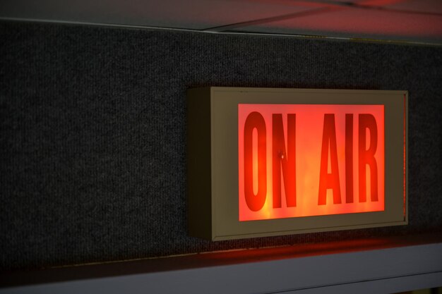 Closeup shot of a red glowing sign that says "ON AIR"