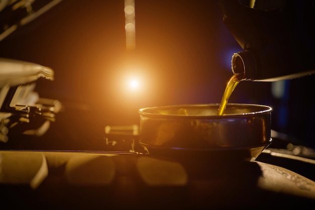 Closeup shot of refueling or pouring engine oil into the engine maintenance car energy fuel concept car maintenance