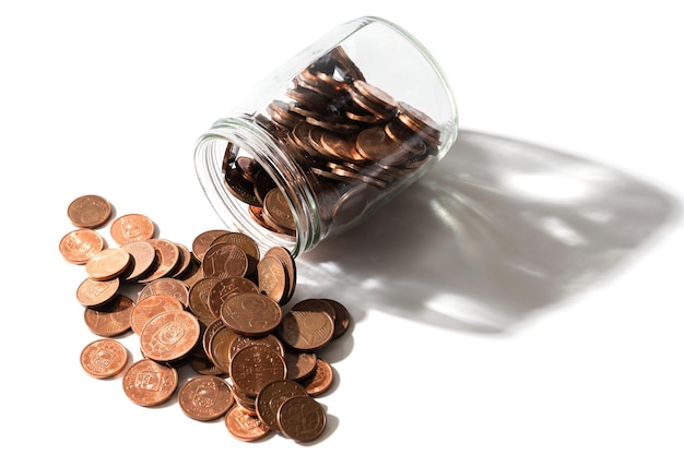 Closeup shot of a shiny copper euro coins spilled from a glass jar