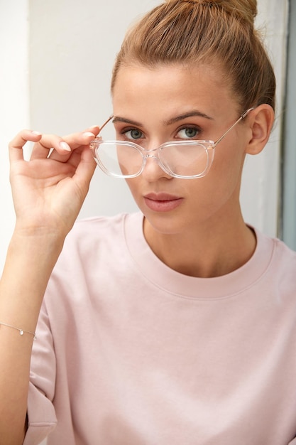 Closeup shot of smiling attractive happy and successful european blond female in sweater watch and glasses grinning expressing confidence looking accomlished and daring at camera with sassy smile