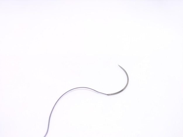 Closeup shot of a surgical suture material isolated on a white background