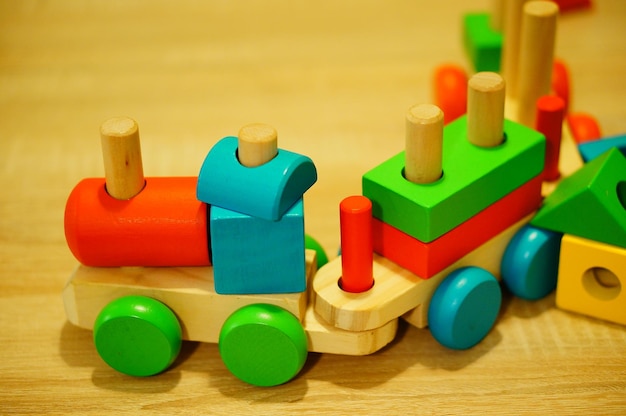 Closeup shot of a toy train with colorful blocks on a wooden surface