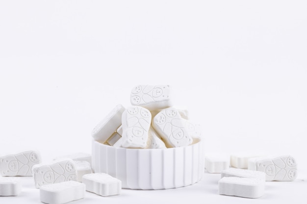 Closeup shot of white pills for children on a white background