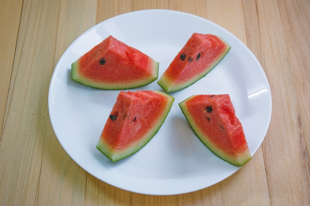 Closeup slice pieces of refreshing watermelon on a wooden space