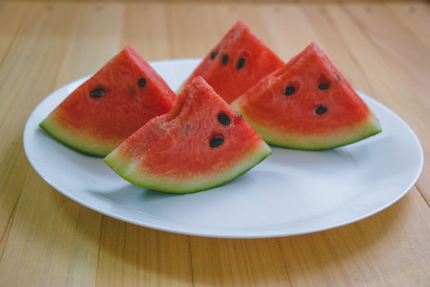 Closeup slice pieces of refreshing watermelon on a wooden space