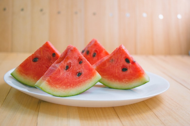 Closeup slice pieces of refreshing watermelon on a wooden space