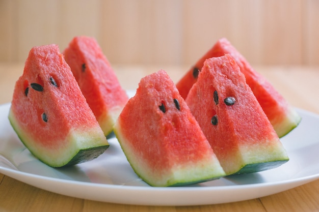 Closeup slice pieces of refreshing watermelon on a wooden space