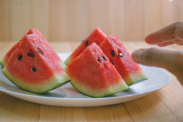 Closeup slice pieces of refreshing watermelon on a wooden space