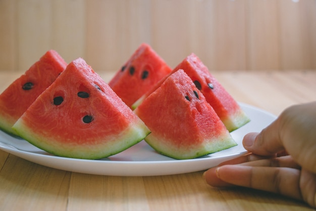 Closeup slice pieces of refreshing watermelon on a wooden space