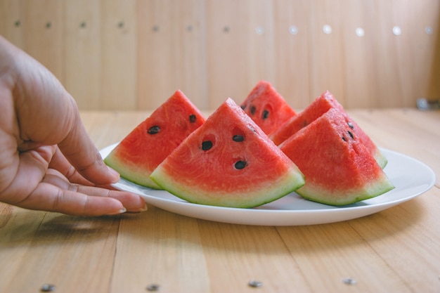 Closeup slice pieces of refreshing watermelon on a wooden space