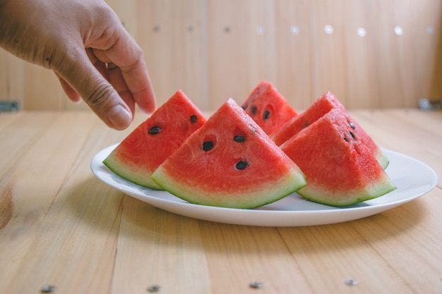 Closeup slice pieces of refreshing watermelon on a wooden space