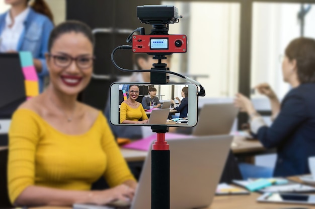 Closeup smart mobile phone taking Live of Businesswoman working