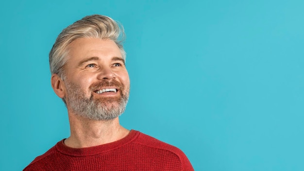 Closeup of smiling middle aged man looking at copy space