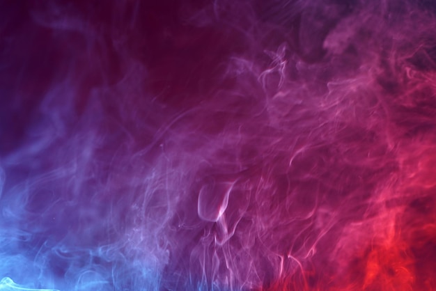 Closeup of smoke under the lights on a colorful background - perfect for wallpapers