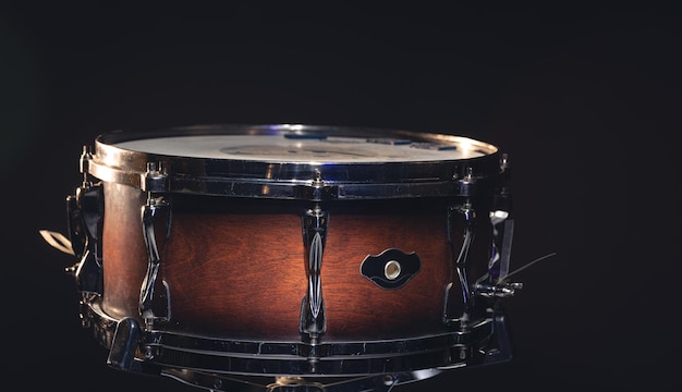 Closeup snare drum on a dark background isolated