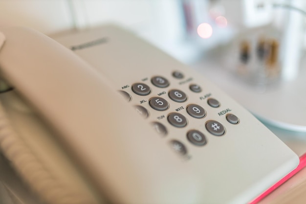 Closeup soft focus on telephone devices at office desk Communication technology concept