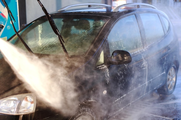 Closeup of someone washing a car at a selfservice car wash