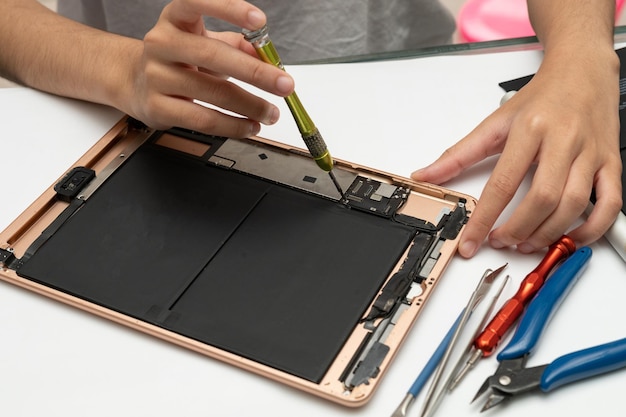 Closeup specialist process of tablet device repair