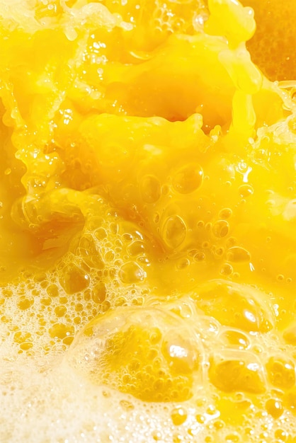 Closeup of splashing orange juice top view Splash of fresh sweet orange mango fruit juice