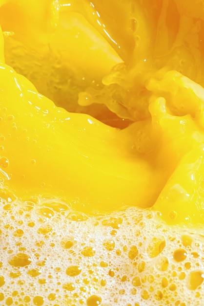 Closeup of splashing orange juice top view splash of fresh sweet orange mango fruit juice