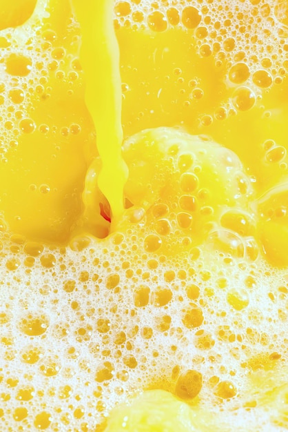 Closeup of splashing orange juice top view Splash of fresh sweet orange mango fruit juice