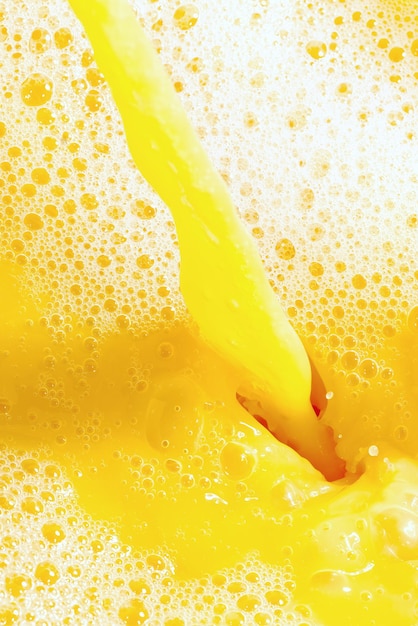 Closeup of splashing orange juice top view Splash of fresh sweet orange mango fruit juice