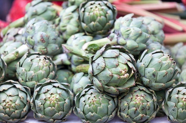 Closeup on a stack of artichokes on a market stall