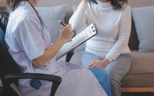 Closeup of stethoscope and paper on background of doctor and patient hands