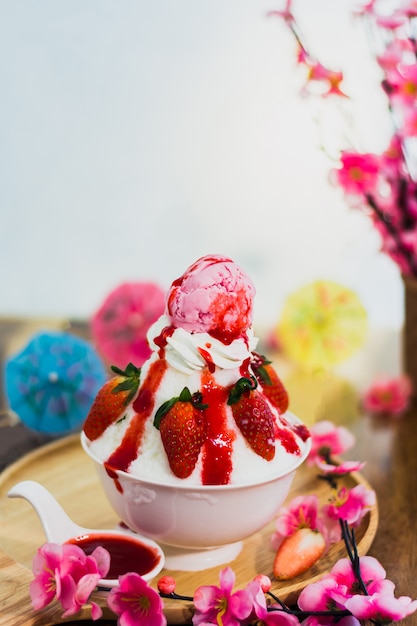 Closeup strawberry Bingsu on tray, Bingsu or Bingsoo, Korean shaved ice dessert with sweet toppings 