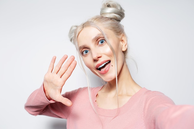 Closeup studio portrait of beautiful happy blonde girl on white background