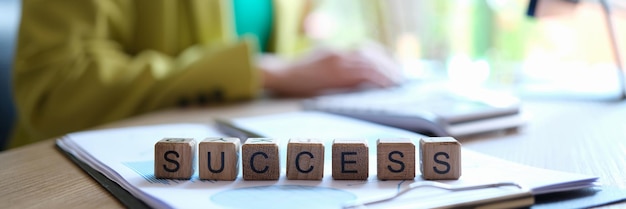 Closeup of success word collected with wooden cubes in row goal achievement targeting and