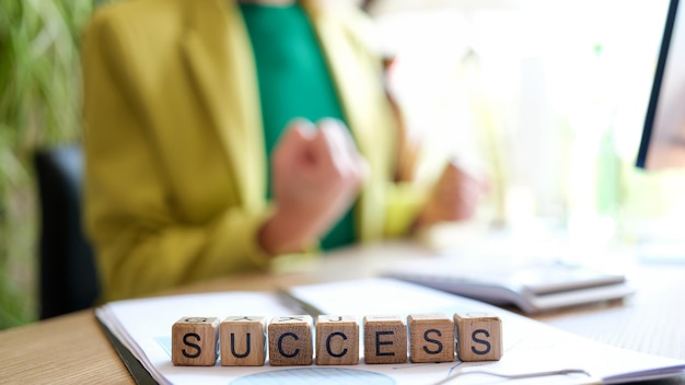 Closeup of success word made with wooden blocks in row on table goal achievement targeting and