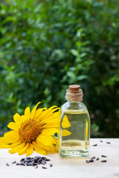 Closeup of sunflower oil in a bottle glass with seeds and sunflower