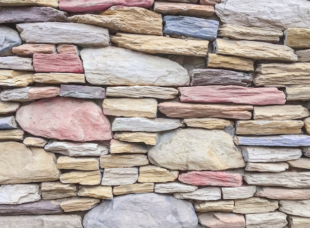 Closeup surface brick pattern at old color stone brick wall textured background