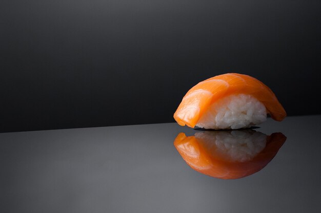 Closeup of sushi with rice on grey  background with reflection