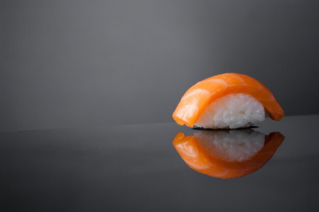 Closeup of sushi with rice on grey  background with reflection