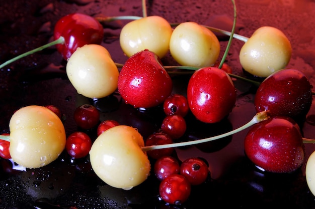 Closeup of sweet berries with drops of water on a dark background Healthy food concept