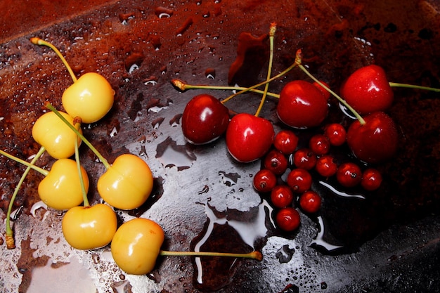 Closeup of sweet berries with drops of water on a dark background Healthy food concept