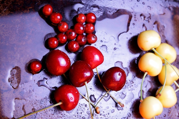 Closeup of sweet berries with drops of water on a dark background Healthy food concept