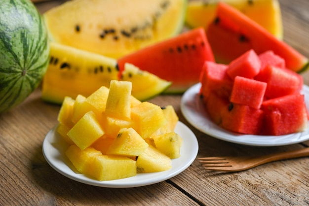 Closeup sweet watermelon slices pieces fresh watermelon tropical summer fruit Red and yellow watermelon slice on plate and wooden background