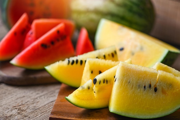 Closeup sweet watermelon slices pieces fresh watermelon tropical summer fruit red and yellow watermelon slice on wooden cutting board