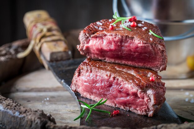 Closeup of tasty steak with rosemary and salt