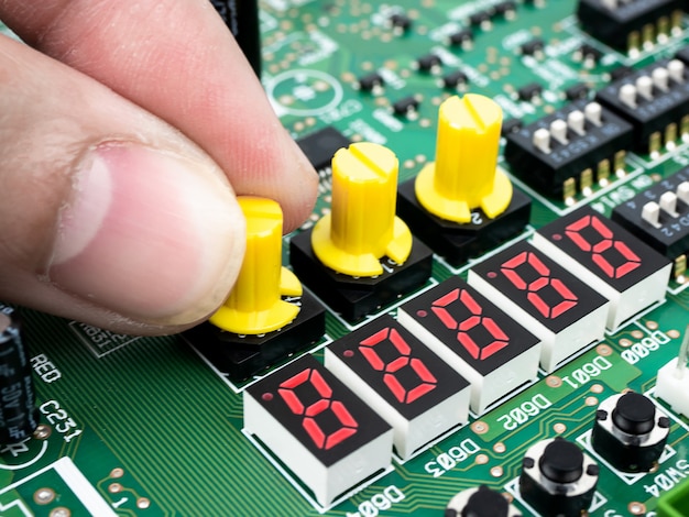 Closeup of a technician's hands checking electronic PCB (Printed circuit board) with microchips processor technology