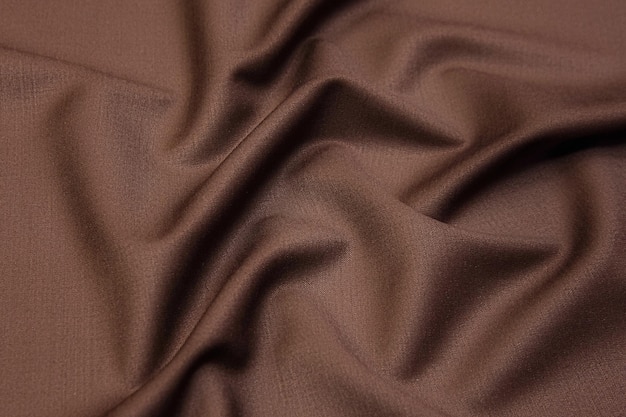 Closeup texture of natural beige fabric or cloth in brown color Fabric texture of natural cotton or linen textile material Beige canvas background