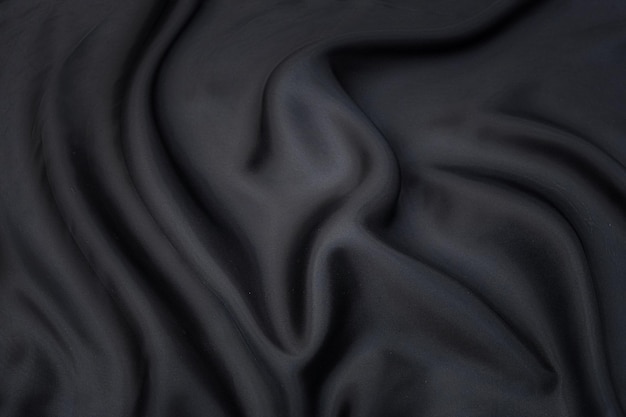 Closeup texture of natural gray fabric or cloth in black color Fabric texture of natural cotton or linen textile material Gray or black canvas background