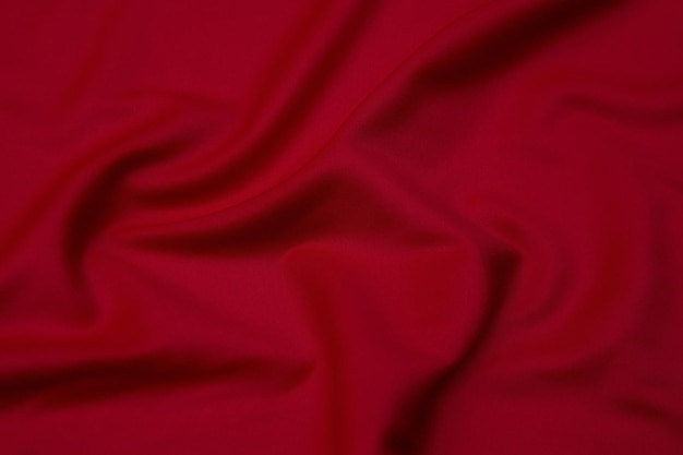 Closeup texture of natural red or pink fabric or cloth in same color Fabric texture of natural cotton silk or wool or linen textile material Red canvas background